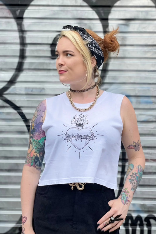 White cropped tank with raw arm holes with tattoo style gothic sacred heart in black on the front & jayne doe is dead printed on the back.