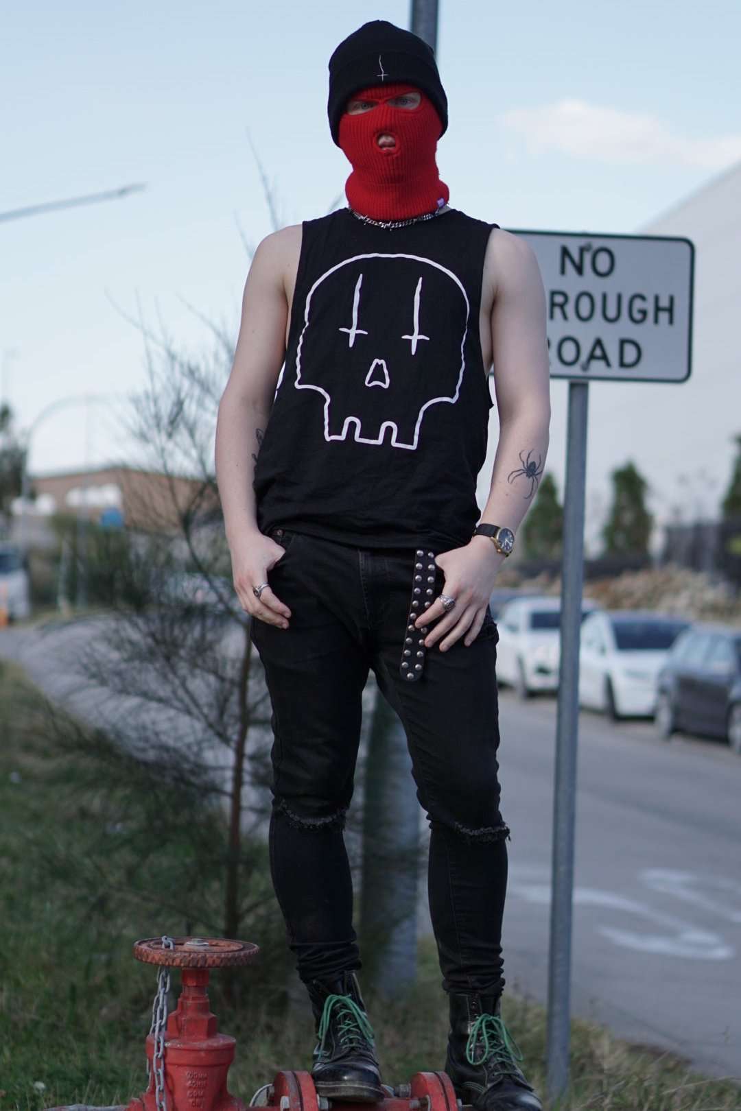 Guy wearing black tank top with large white skull print on the front