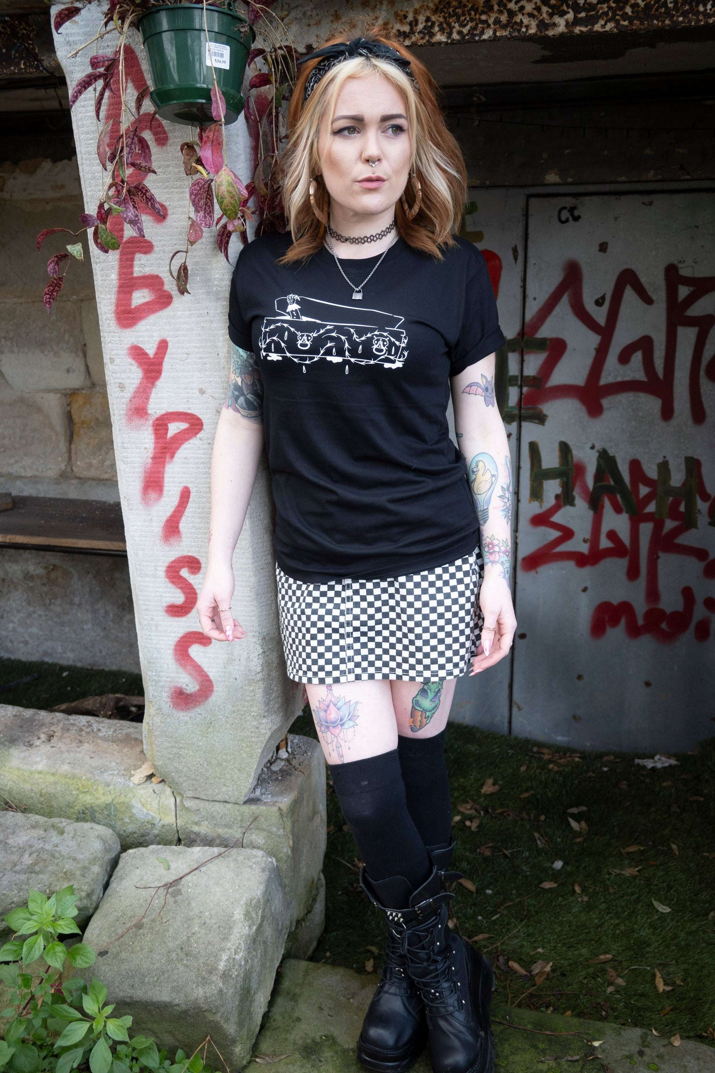 Black tshirt with intricate coffin with vampire hand emerging on the front
