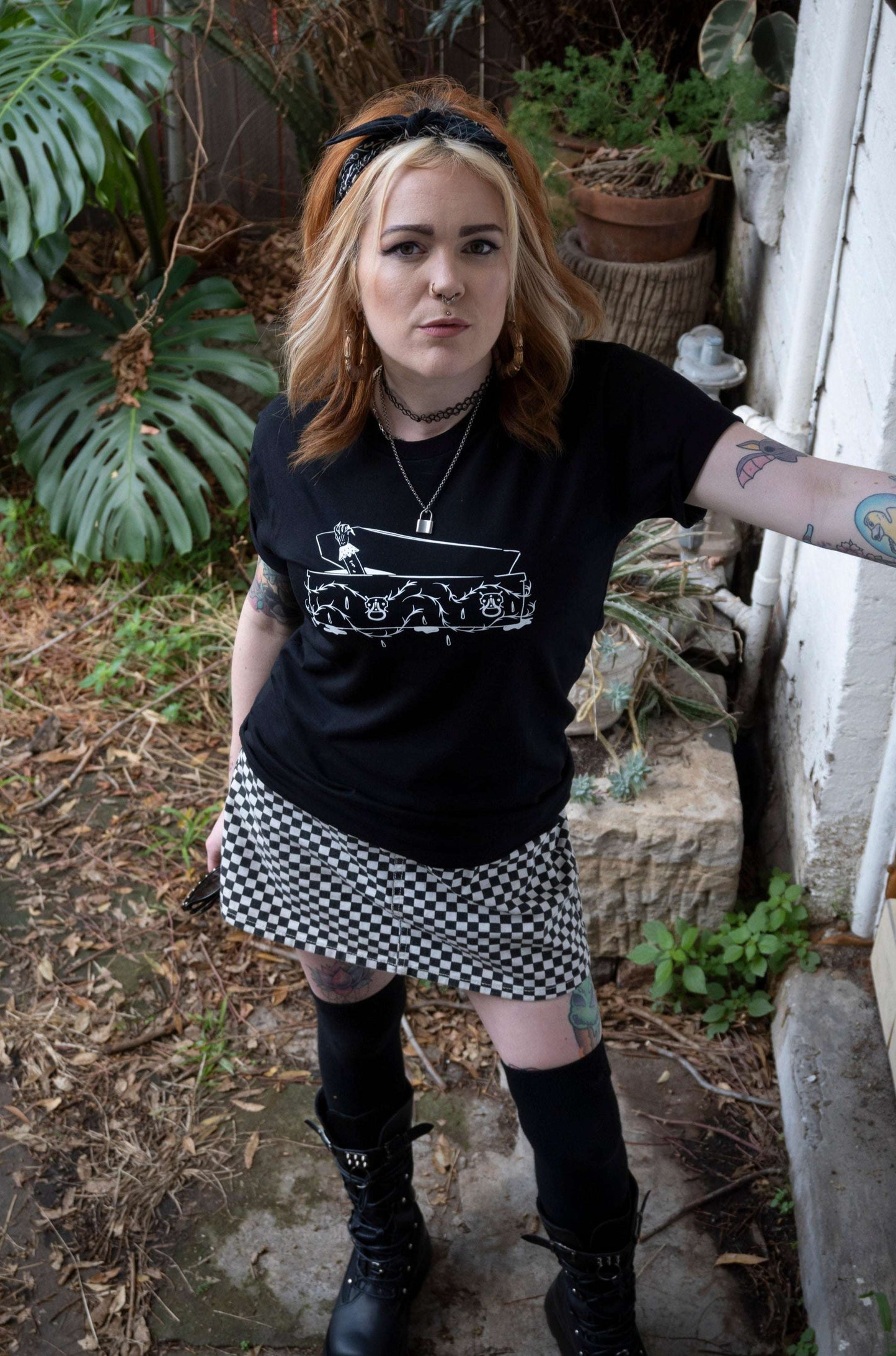 Black tshirt with intricate coffin with vampire hand emerging on the front