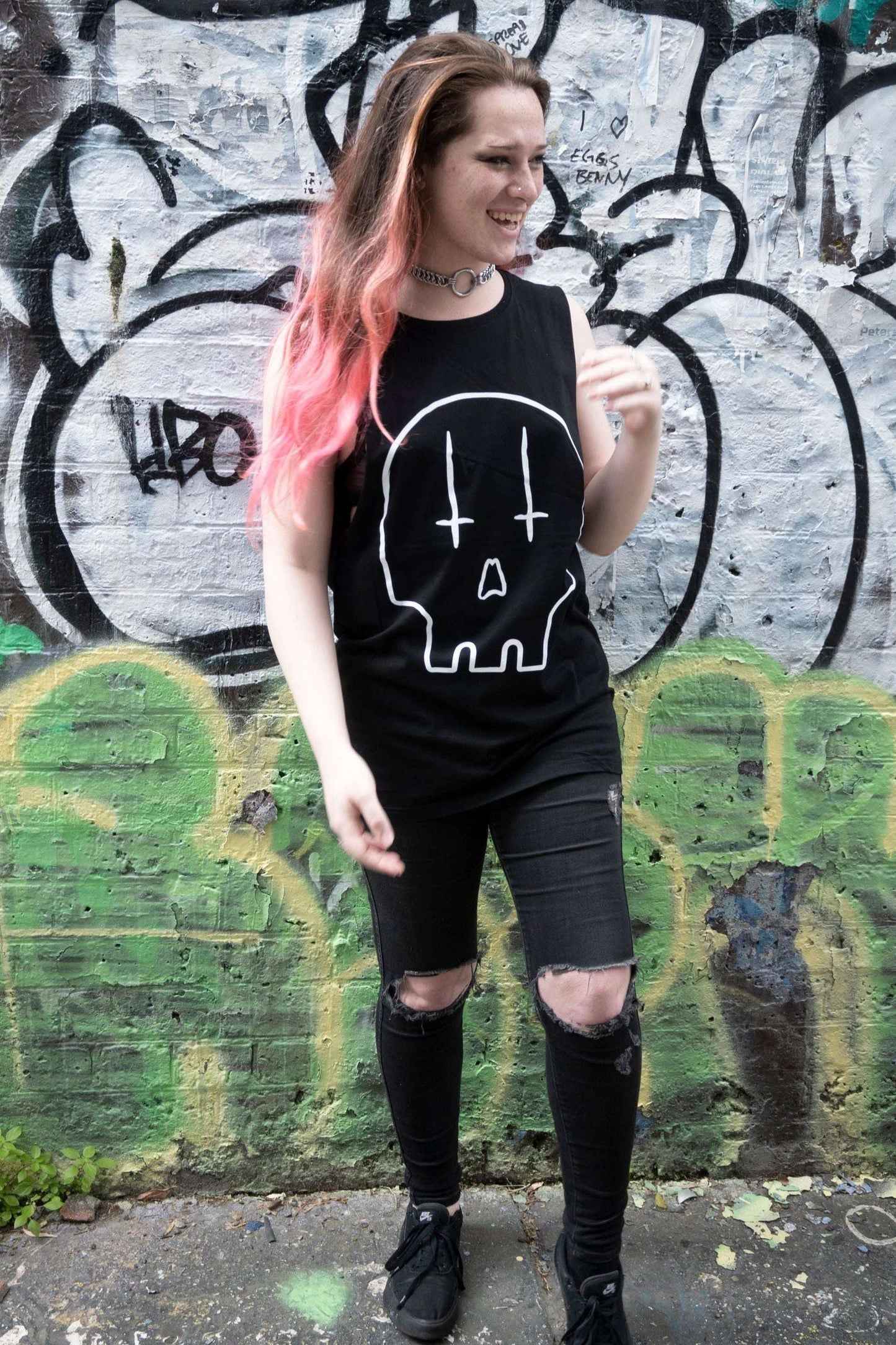 Black tank with raw edge arm holes, with huge skull rpint in white with upside down crosses for eyes.