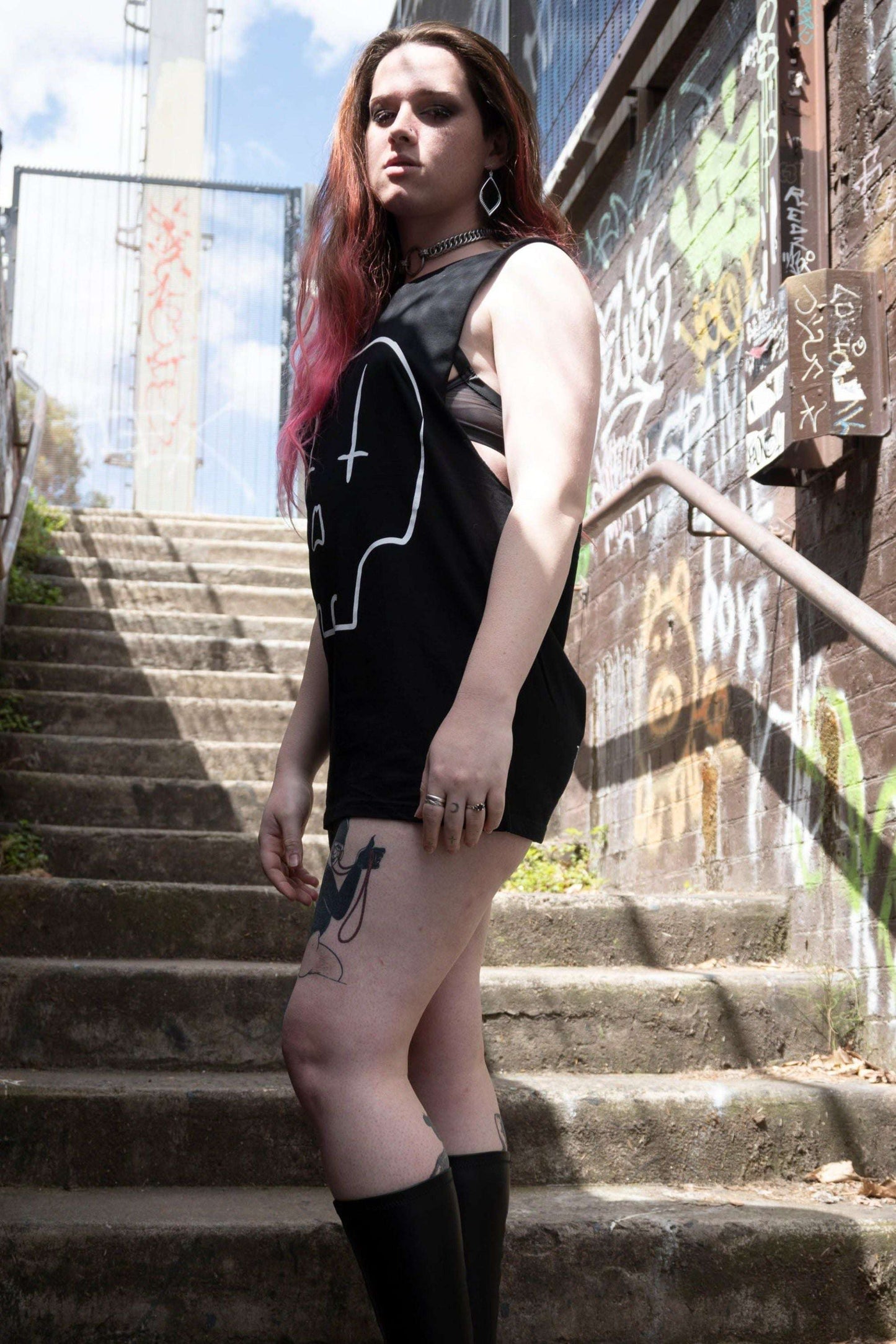 Black tank with raw edge arm holes, with huge skull print in white with upside down crosses for eyes.