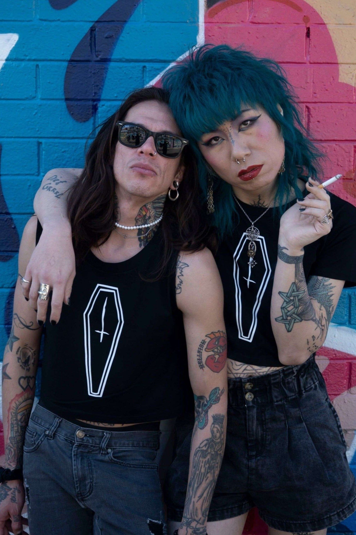 Black cropped tank top with coffin motif printed in white with upside down cross, with the same design also in a cropped tee