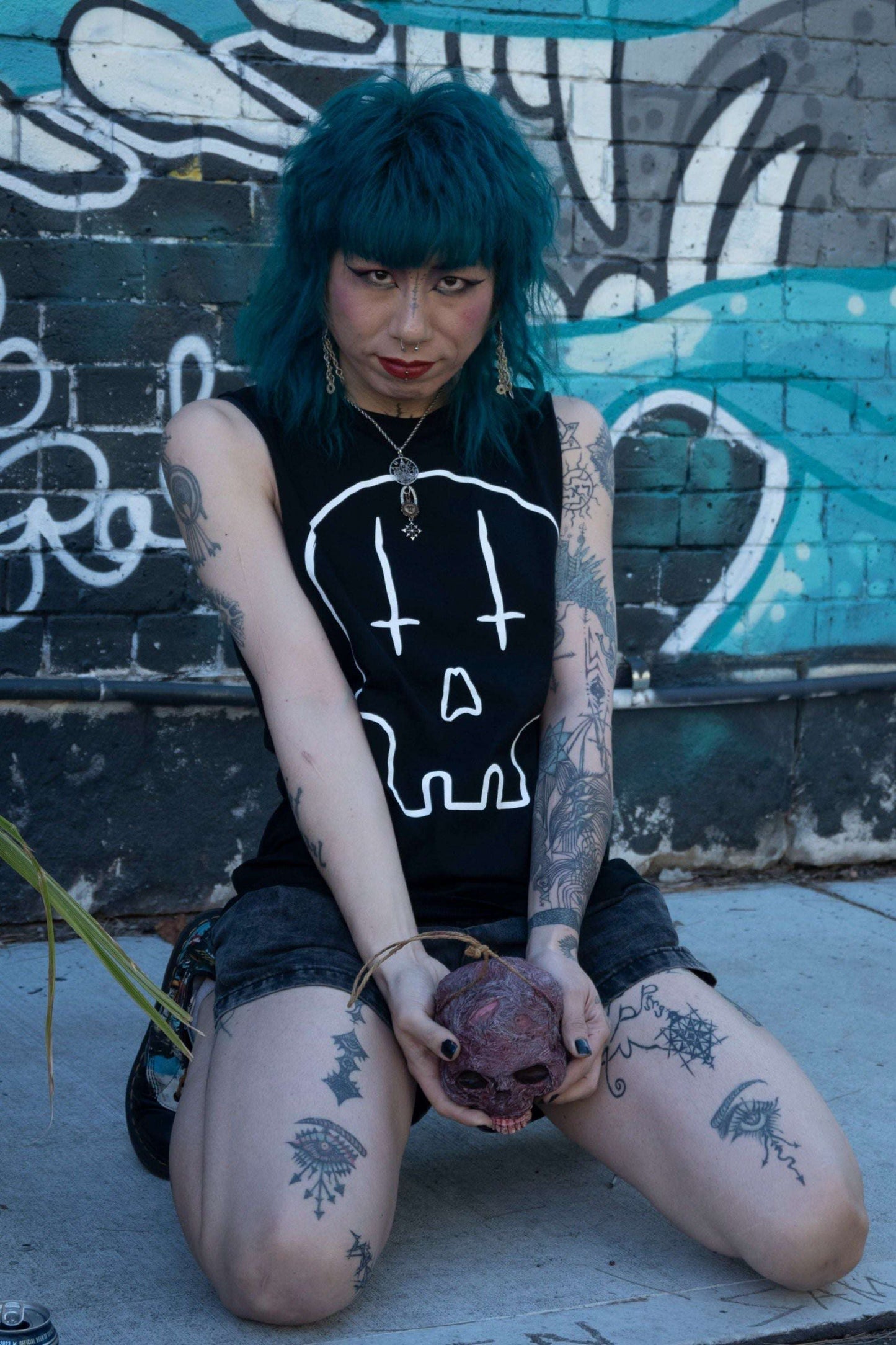 Black tank with raw edge arm holes, with huge skull print in white with upside down crosses for eyes