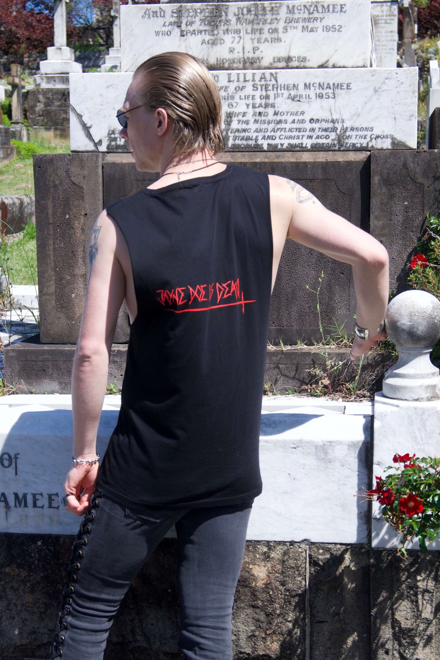 Back view of Queen of Hearts Tank/Dress featuring 'Jayne Doe is Dead' red gothic text, styled in punk streetwear fashion.