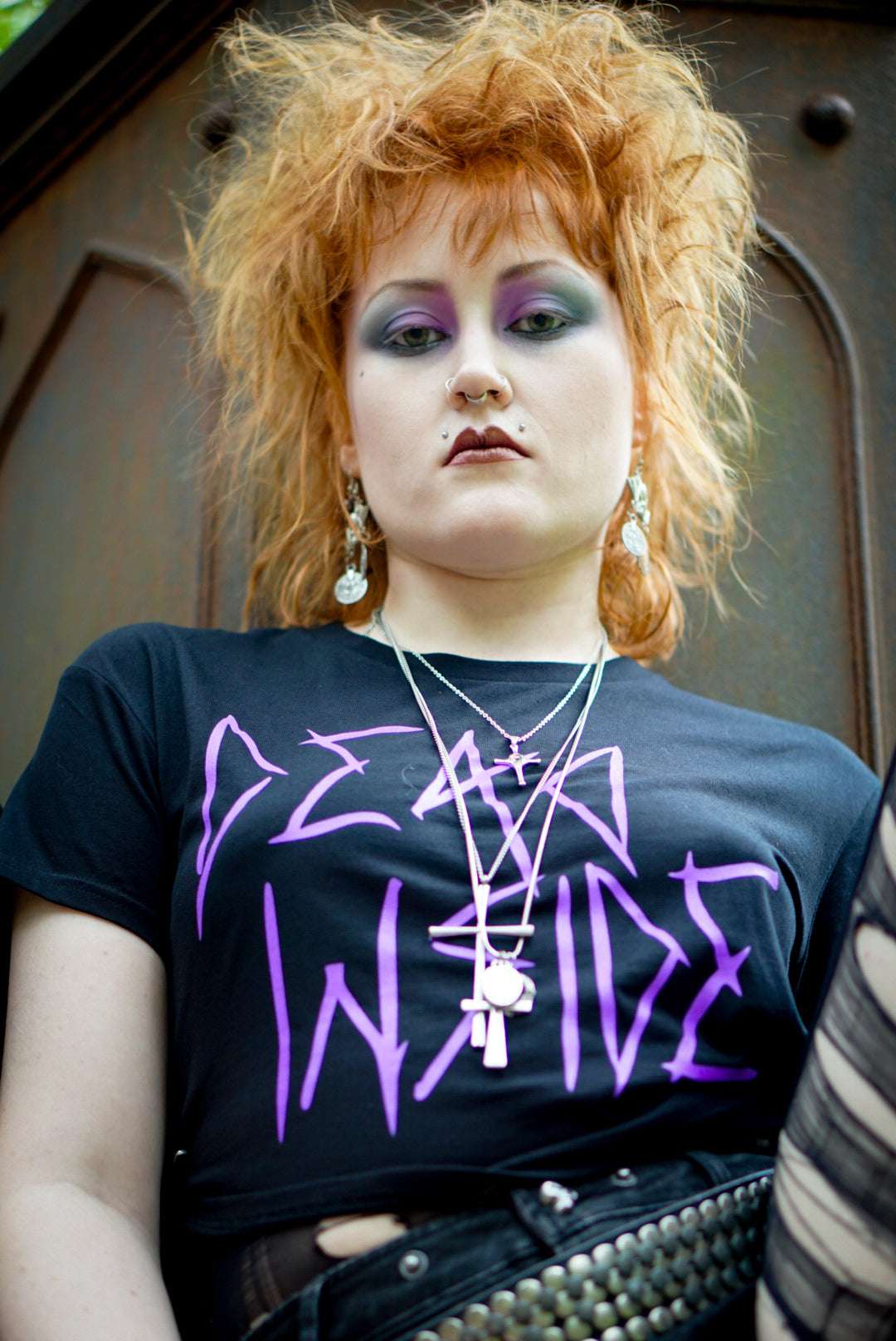 Goth girl wearing a black cropped Tshirt with dead inside printed on the front in purple gothic style font