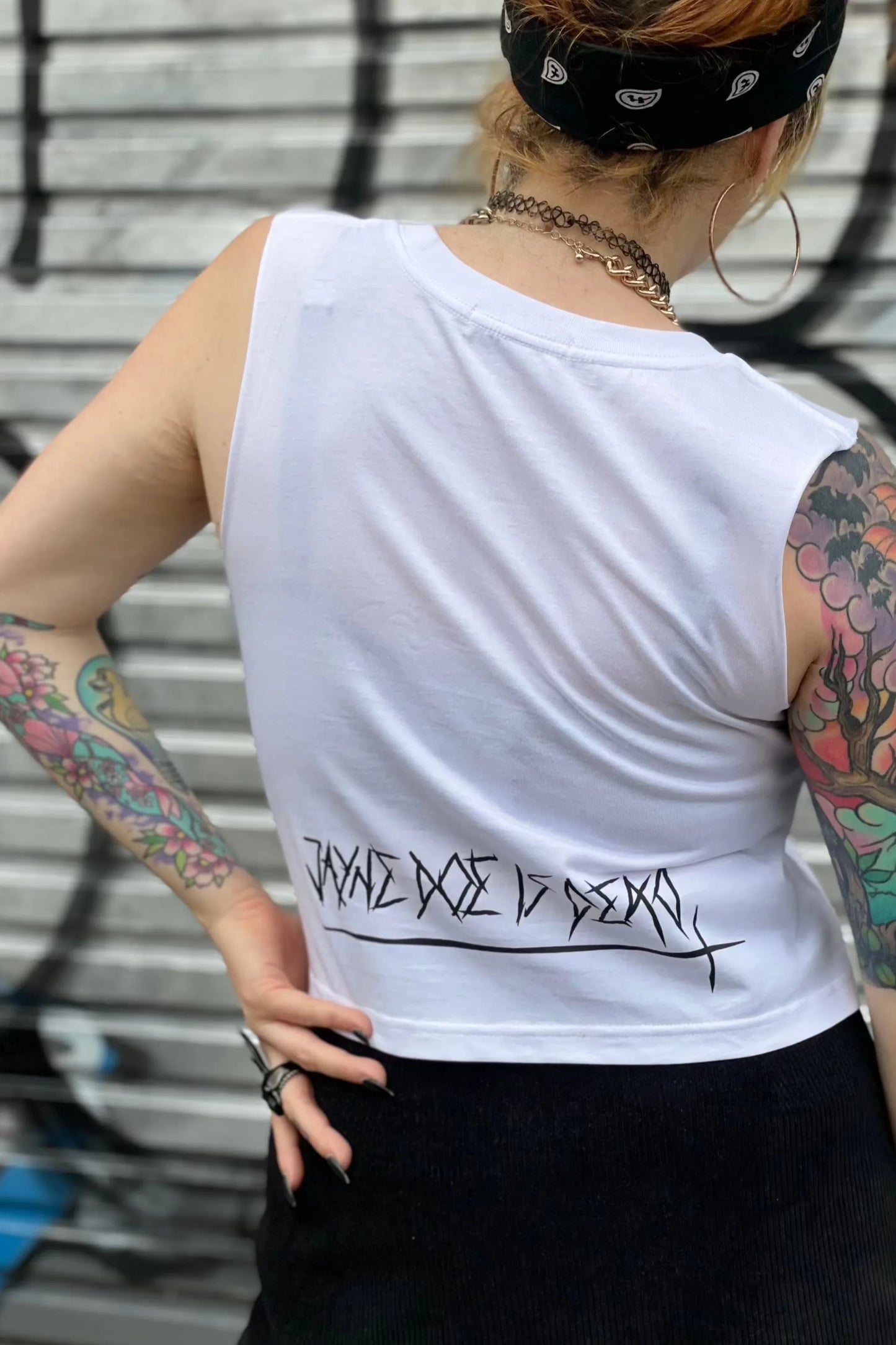 Back of white cropped tank top with Jayne doe is dead logo printed in black