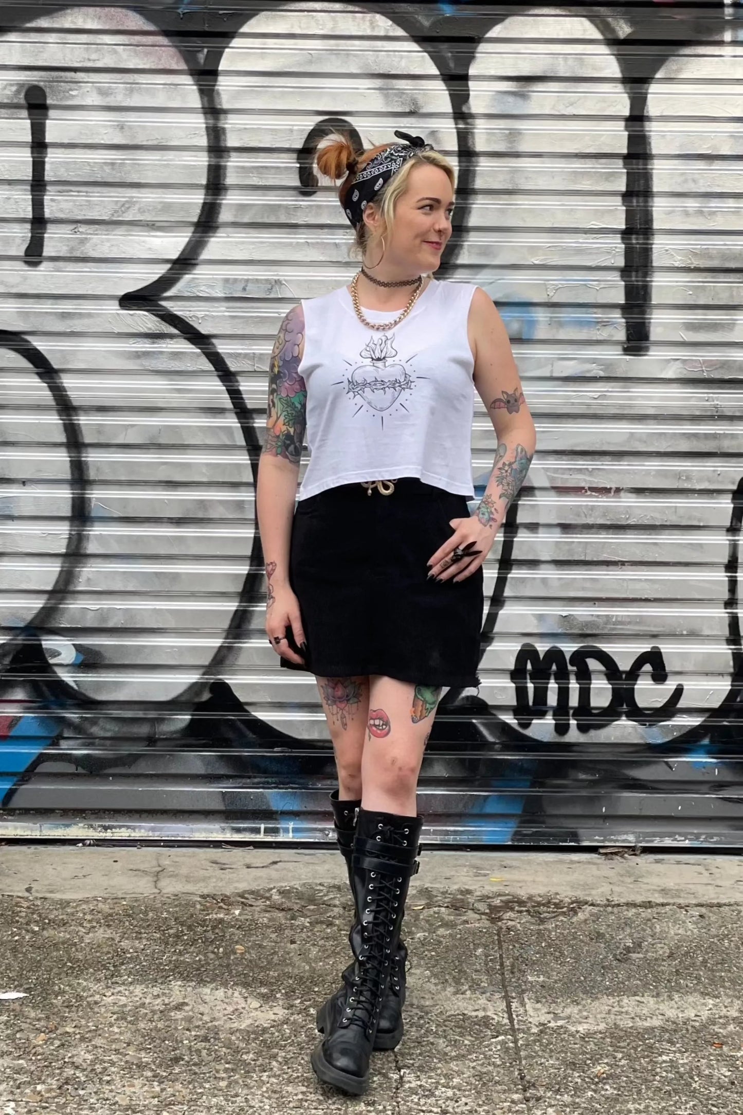 White cropped tank with raw arm holes with tattoo style gothic sacred heart in black on the front & jayne doe is dead printed on the back.