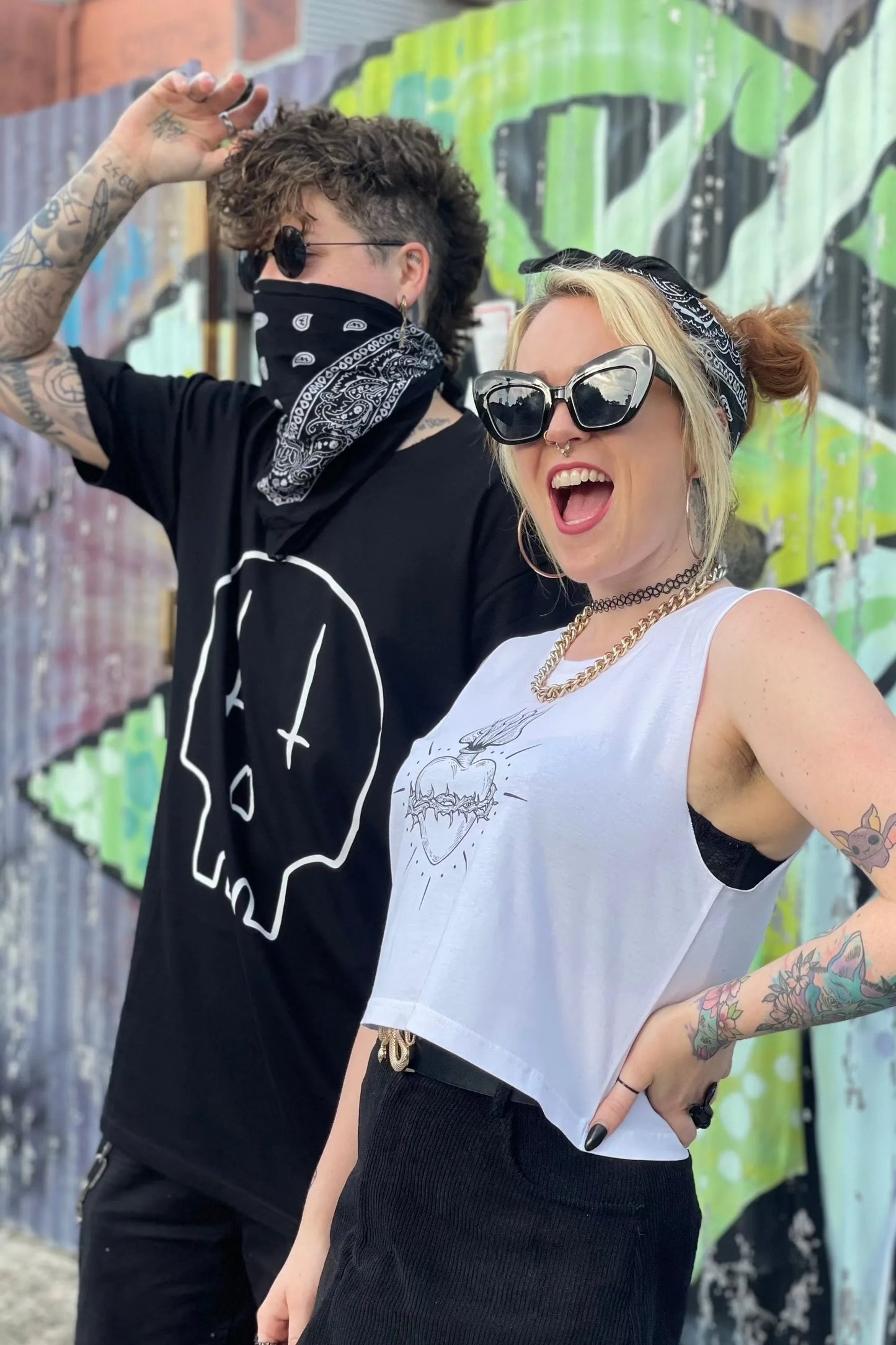 White cropped tank with raw arm holes with tattoo style gothic sacred heart in black on the front & jayne doe is dead printed on the back.