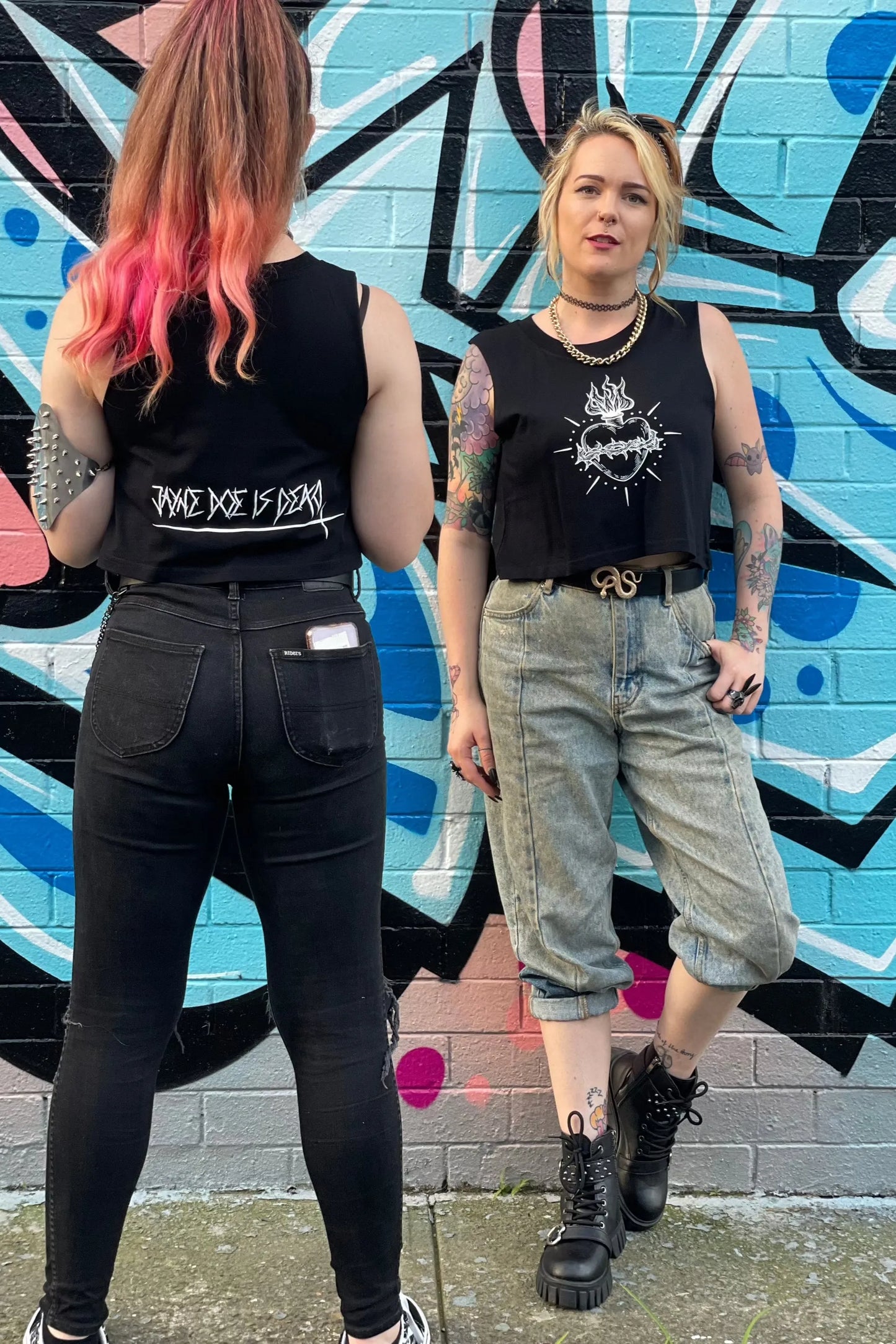 Black cropped tank with raw arm holes with tattoo style gothic sacred heart in white on the front & jayne doe is dead printed on the back.