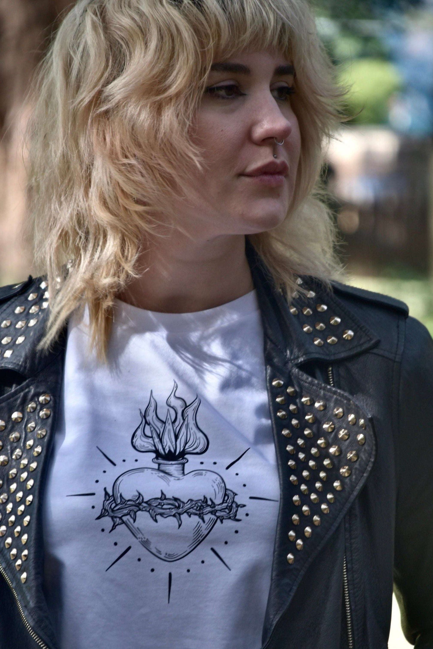white cropped tshirt with black scared heart print with vines & flames, paired with studded leather jacket