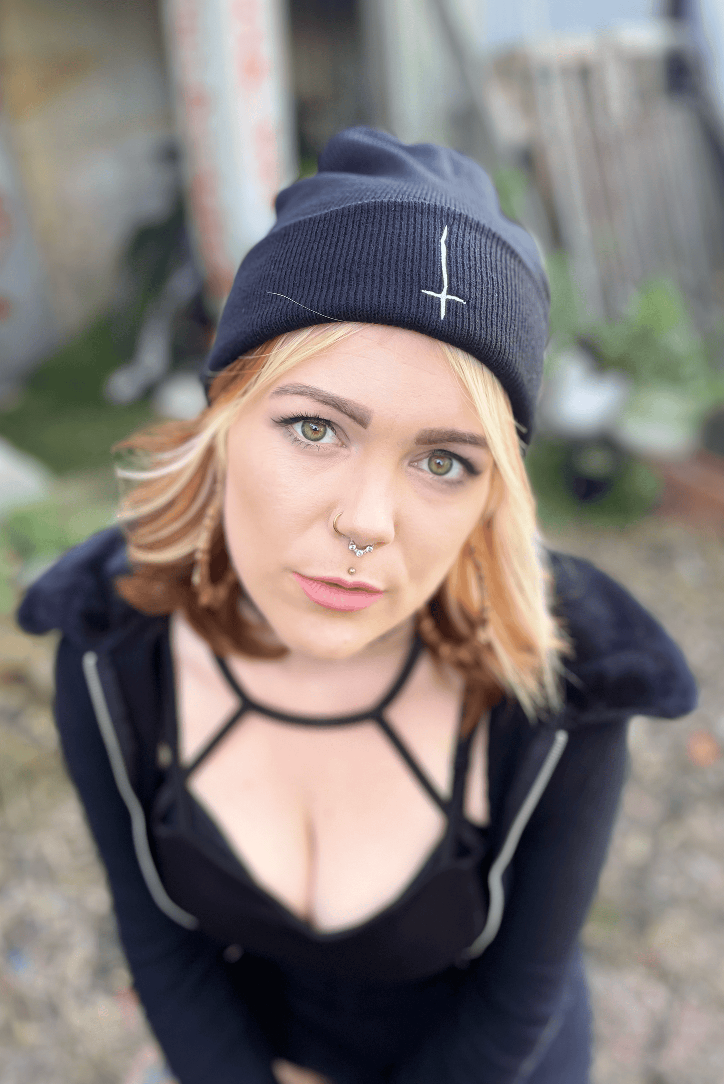 Black tight knit beanie with upside down white crossed embroidered on the front cuff