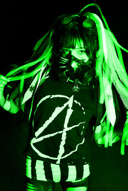 Cybergoth girl in post apocalyptic scene, wearing a black cropped tshirt with a big white A (for anarchy) print on the front