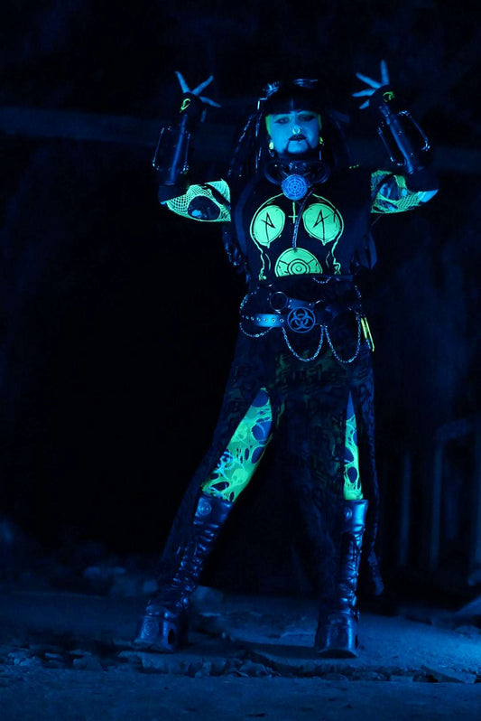 Cyber goth dressed in black cropped tshirt with drone print in UV glowing toxic green