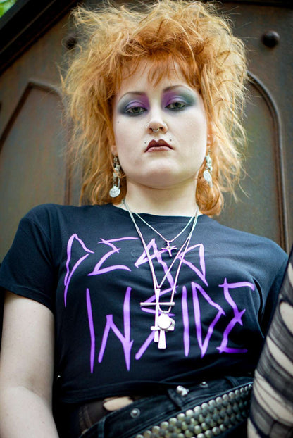 Goth girl wearing a black cropped Tshirt with dead inside printed on the front in purple gothic style font