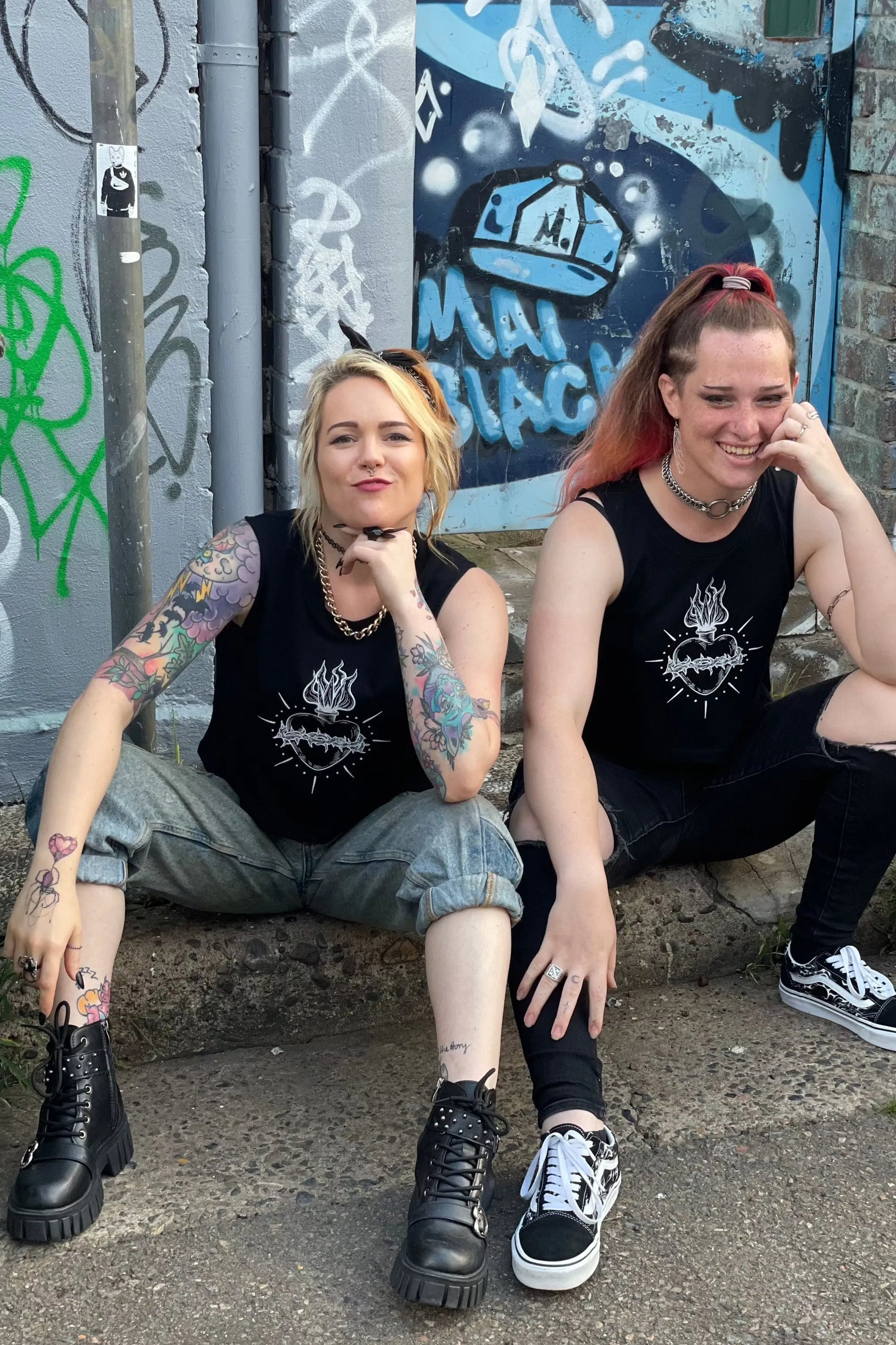 Black cropped tank with raw arm holes with tattoo style gothic sacred heart in white on the front & jayne doe is dead printed on the back.